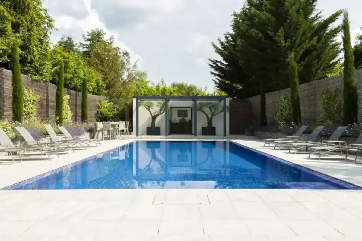 A modern pool serving as a focal point by Raine Garden Design.